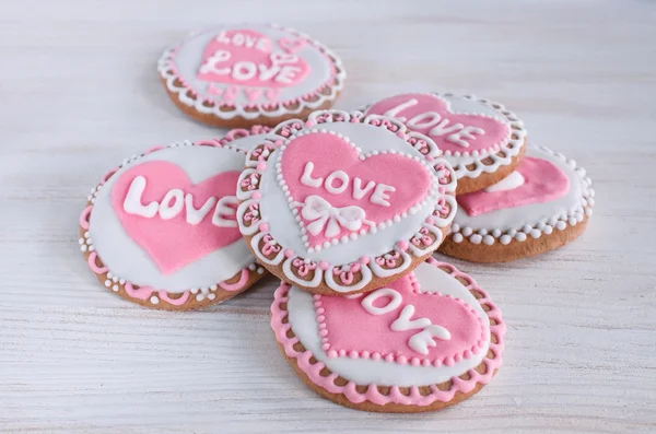 Homemade cookies with pink frosting in the shape of hearts