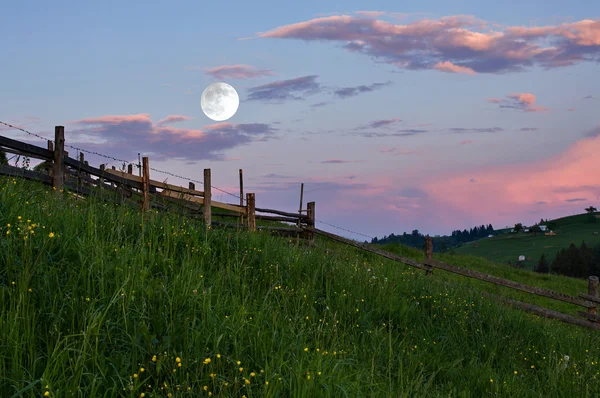 Rural landscape with a full moon