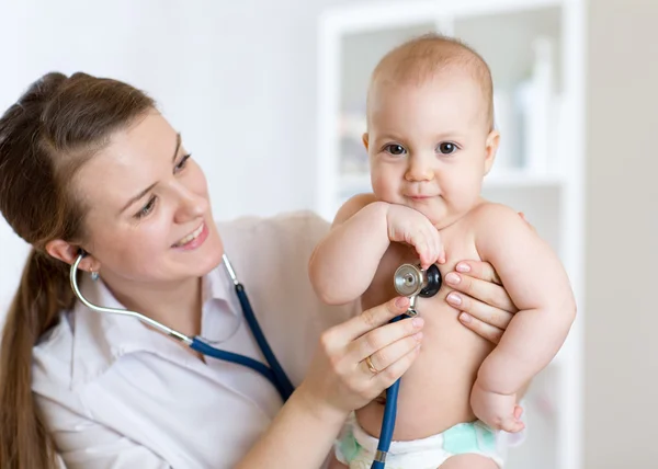 Female pediatrician examining of child in hospital