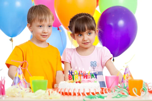 Smiling kids with birthday cake and color ballons