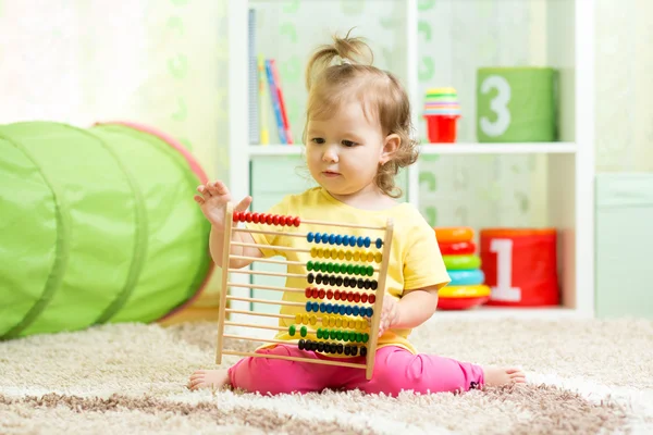 Child girl playing with abacus, early learning