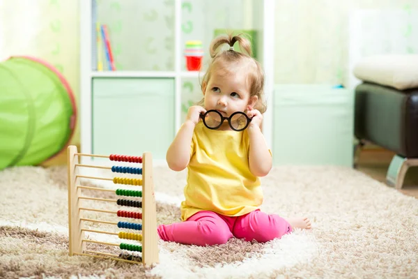 Kid girl playing with abacus, early learning