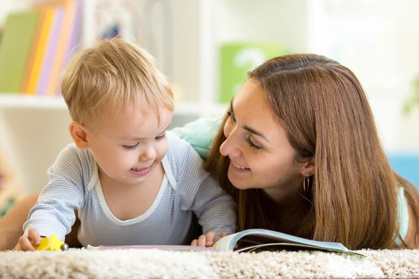 Mother reading a book to kid at home