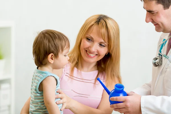 Doctor counseling mother and boy about nasal irrigation