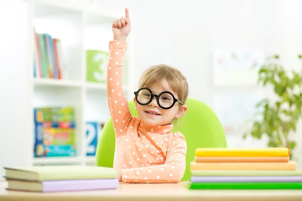 Clever kid child girl with books indoors