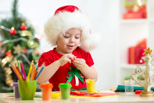 Child making by hands christmas decorations