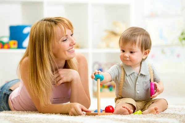 Cute woman and kid playing together indoor