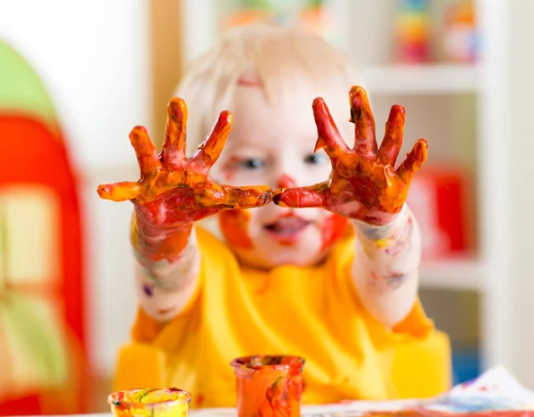 Happy child with painted hands
