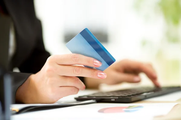 Business woman hands with credit card and keyboard