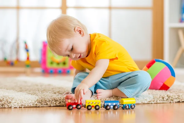 Child boy playing with toys indoor