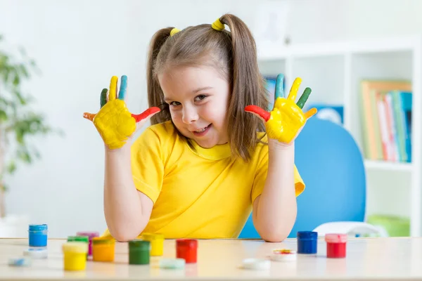 Kid girl showing painted hands