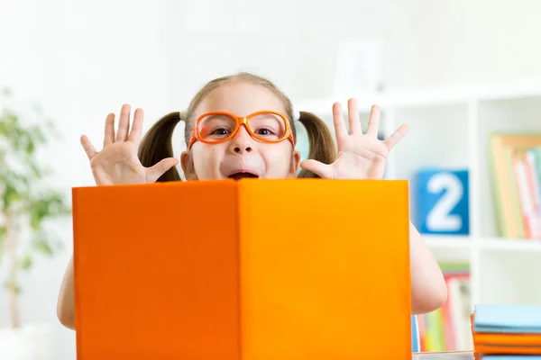 Funny kid girl weared eyeglasses with book