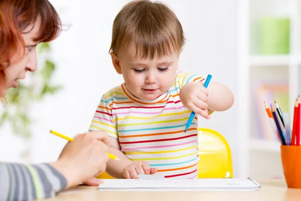 Child painting in nursery at home