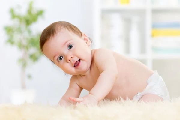 Baby sitting on fluffy carpet at home