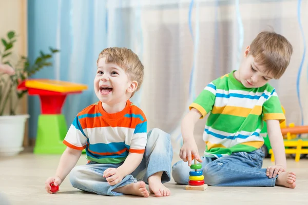 Funny children play with toys indoor
