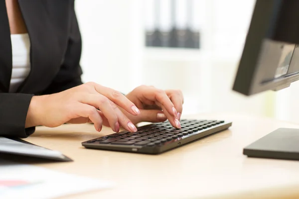 Office worker typing on keyboard