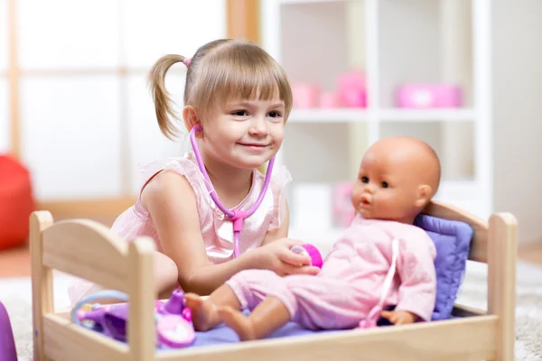 Child Playing Doctor with doll Toy
