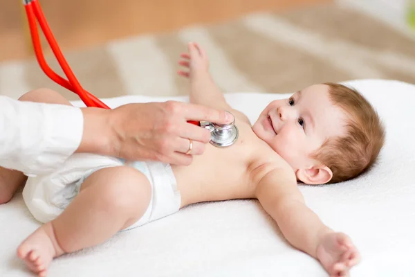 Baby having its heartbeat checked by doctor pediatrist