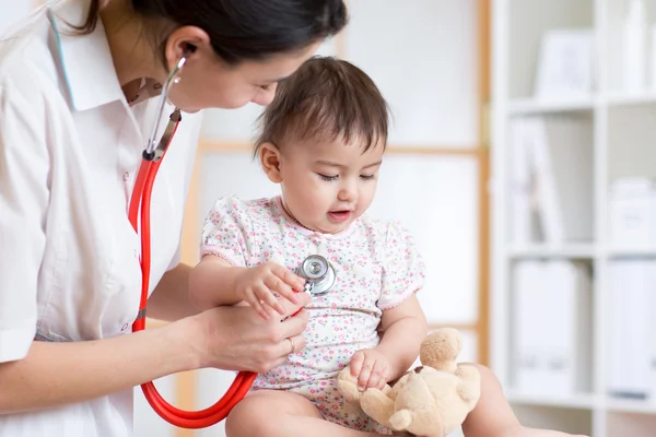 Woman pediatrician examining of baby kid with stethoscope