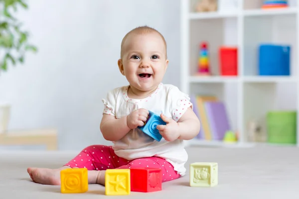 Baby toddler playing color toys at home or nursery