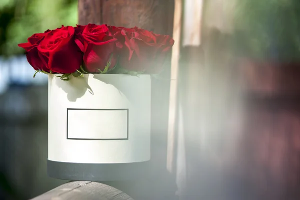 Red roses bouquet in white gift box.