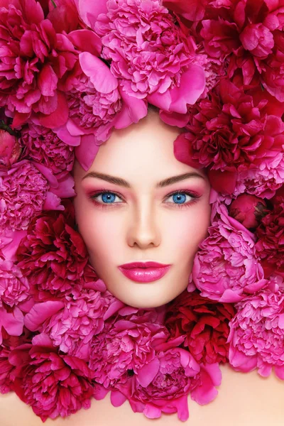 Woman with hot pink peonies