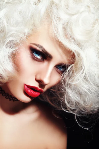 Woman with platinum blonde curly hair