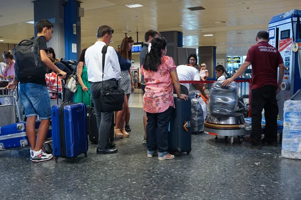 Waiting in Line to have Luggage Wrapped in Cling Film