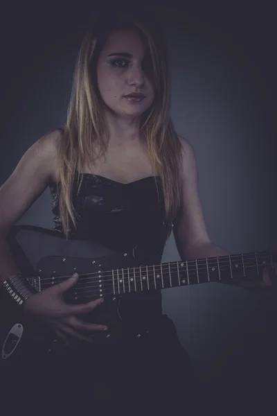 Blonde with black electric guitar