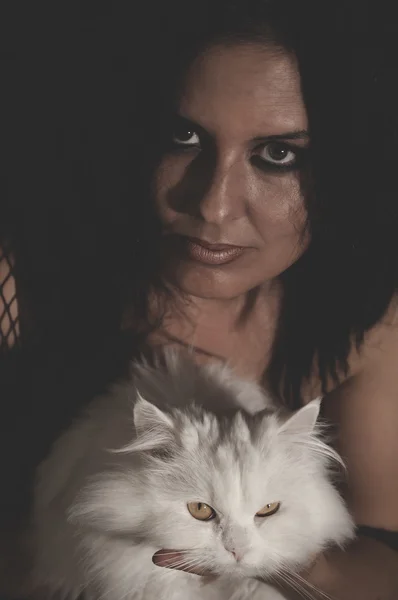 Brunette woman holding cat