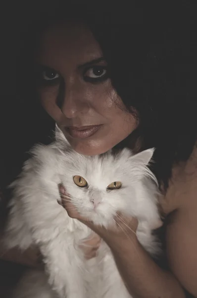 Brunette woman holding cat