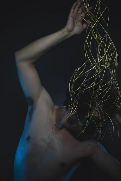 Naked man with a crown of thorns on his head