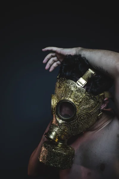 Depression and danger man with golden gas mask