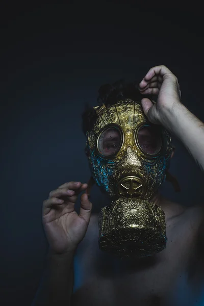 Depression and danger man with golden gas mask