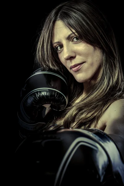 Strong woman athlete with boxing gloves