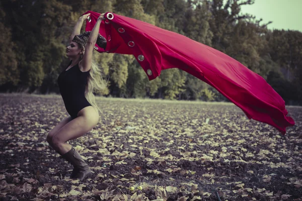 Woman posing  with red cape
