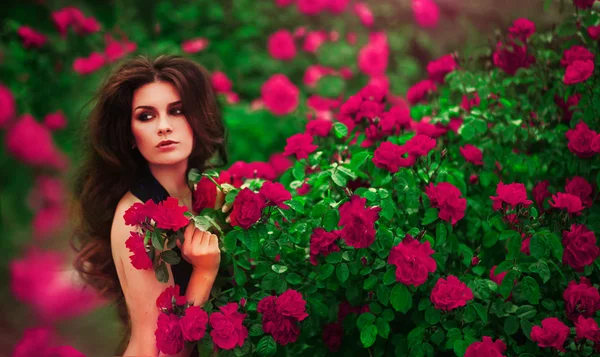 Woman near rose bushes