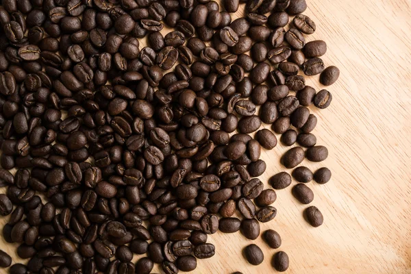 Roasted coffee beans on wood dish