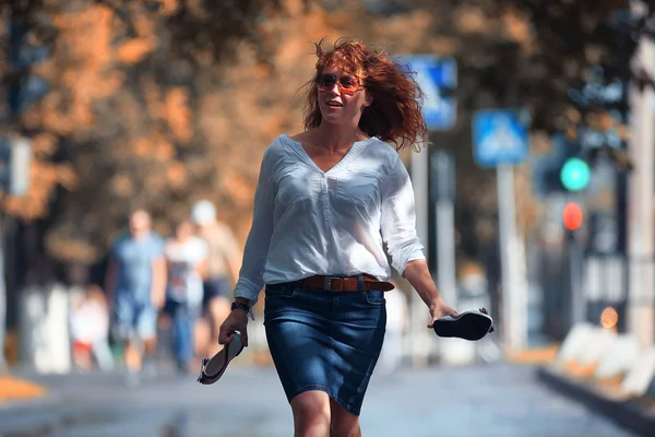 Barefoot girl walking on the street