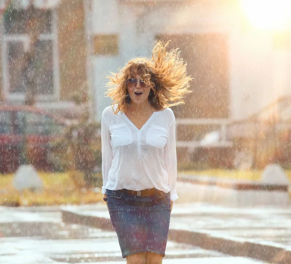 Girl jumping in the puddle