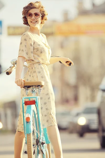 Girl  with a bicycle on the street