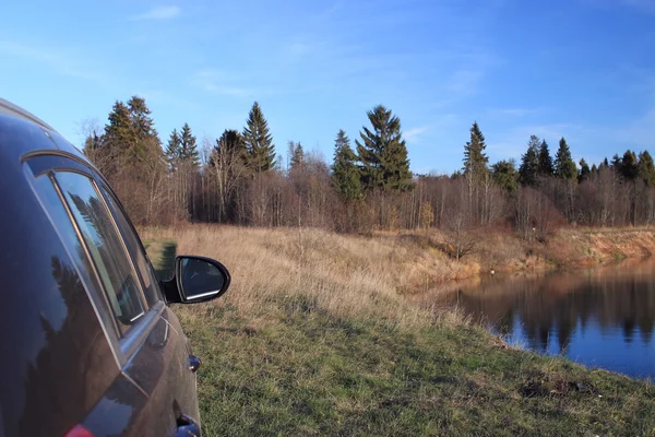 Car in autumn landscape