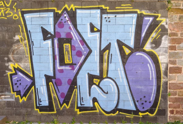 Graffiti painted on a brick wall