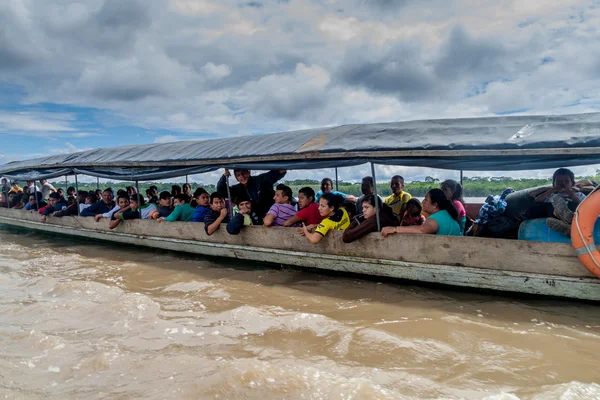 Passengers of a boat traveling a river