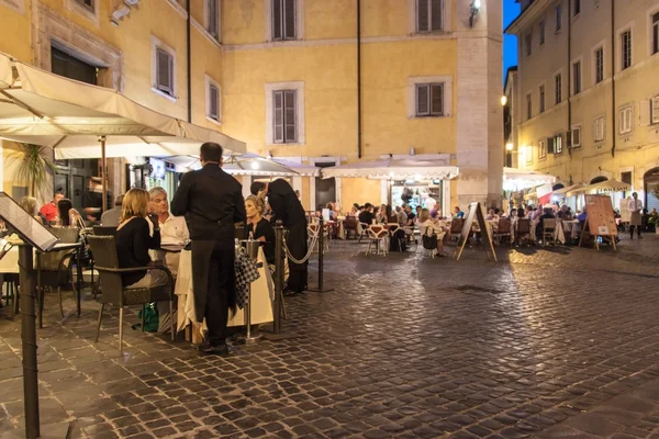 People eat in street restaurants in Rome