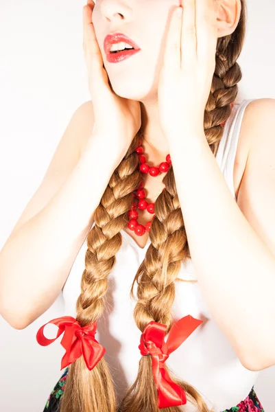 A young beautiful woman with long blonde hair tresses wearing a Polish folk costume