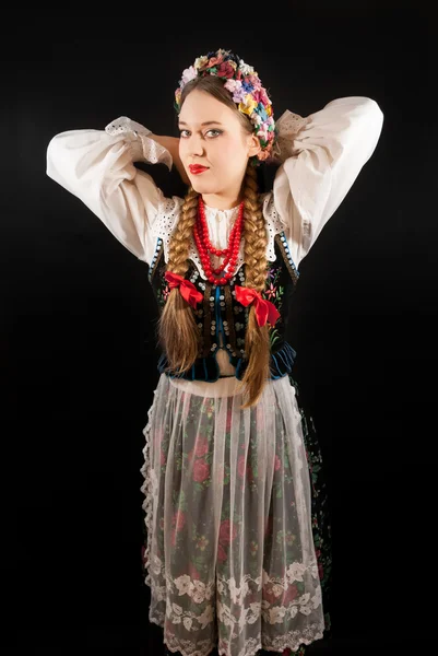 A young beautiful woman wearing a traditional Polish folk costume