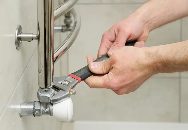 Plumber  sets  valve for towel warmer.