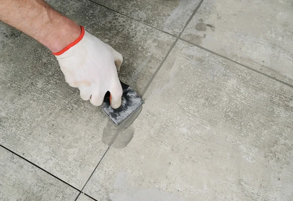 Grouting ceramic tiles.