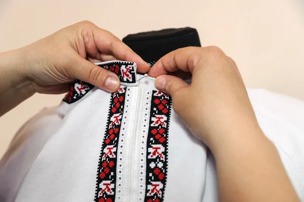 Female tailor captures shirt collar